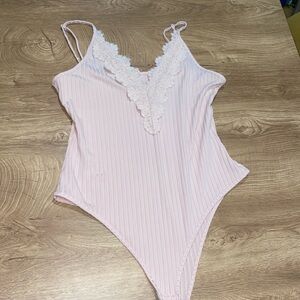 Light pink bodysuit with lace neckline